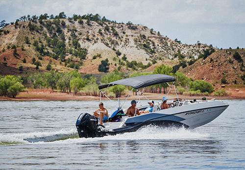 A group of people ride in a boat on a lake.