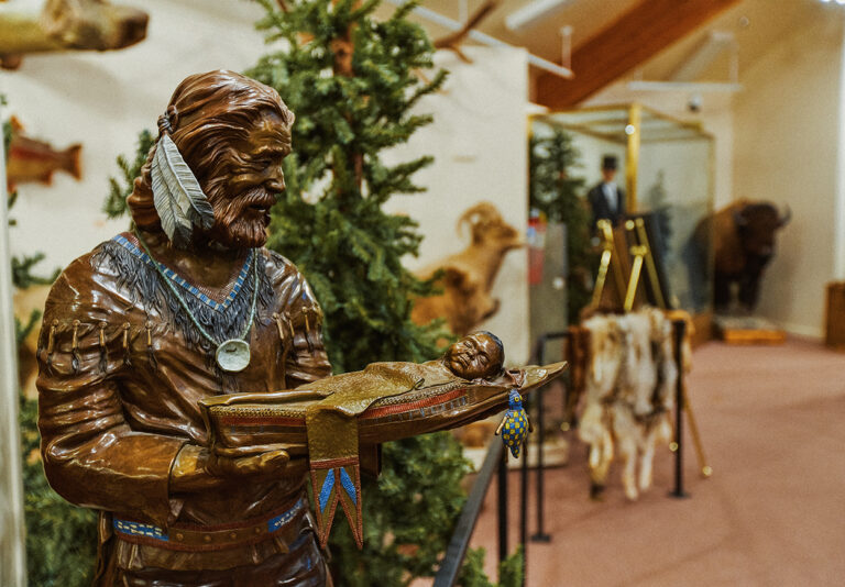 A bronze statue of a man holding a baby.